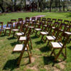 Fruitwood padded folding chairs in use at event