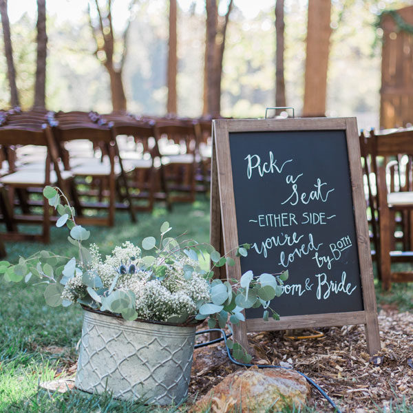 Fruitwood padded folding chairs with chalkboard sign