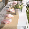 rectangular table in use at an event - with glassware holding the linen napkins