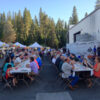 8-ft tables and brown folding chairs in use at an outdoor event