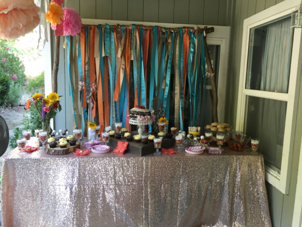 Rectangular folding table with cupcake and cake stands.