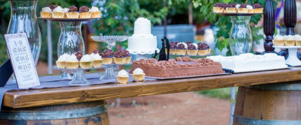 Desserts - using cupcake and cake plates on top of the wine barrel bar.
