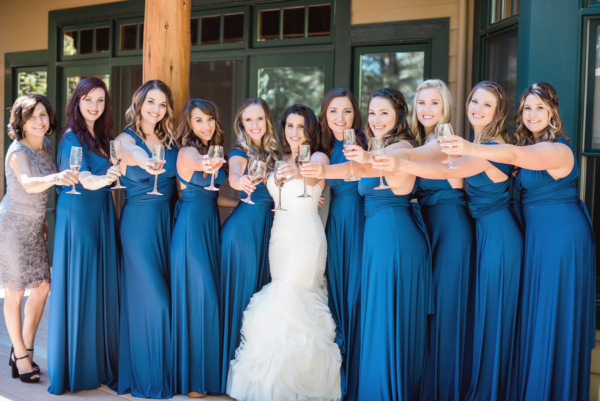 Bridal party using champagne and wine glasses